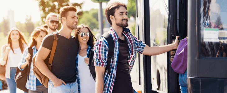 a group of people board a charter bus