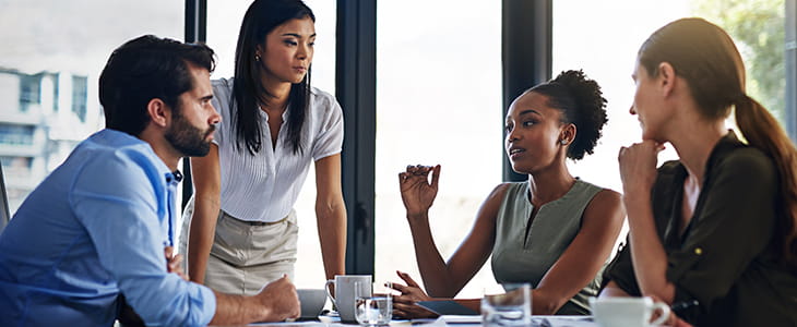 Businesspeople discuss in a meeting room