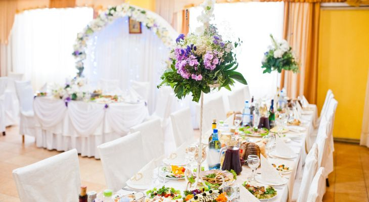 a long dinner table set for a wedding rehearsal dinner