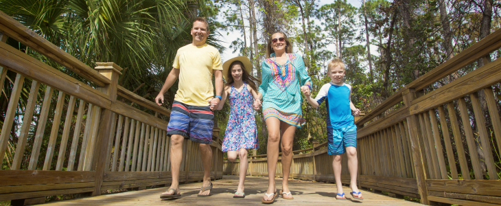 a family walking down a pier