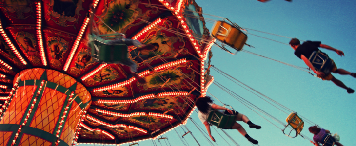 people riding a chairswing ride at an amusement park