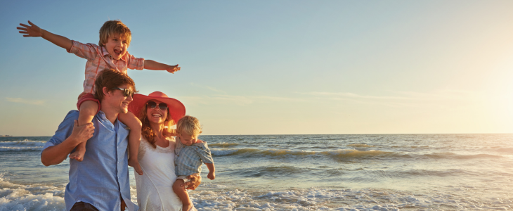 a family smiles while at the beach