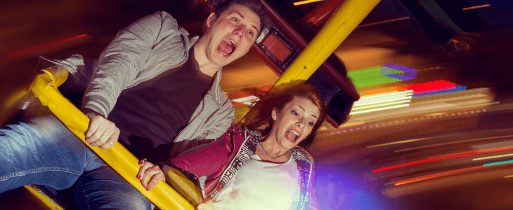 two friends scream on a rollercoaster