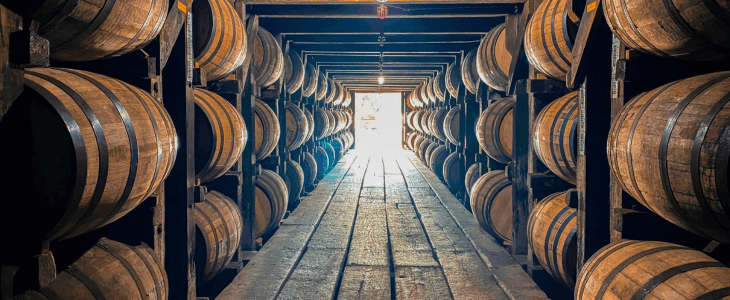 a row of barrels with bourbon in them